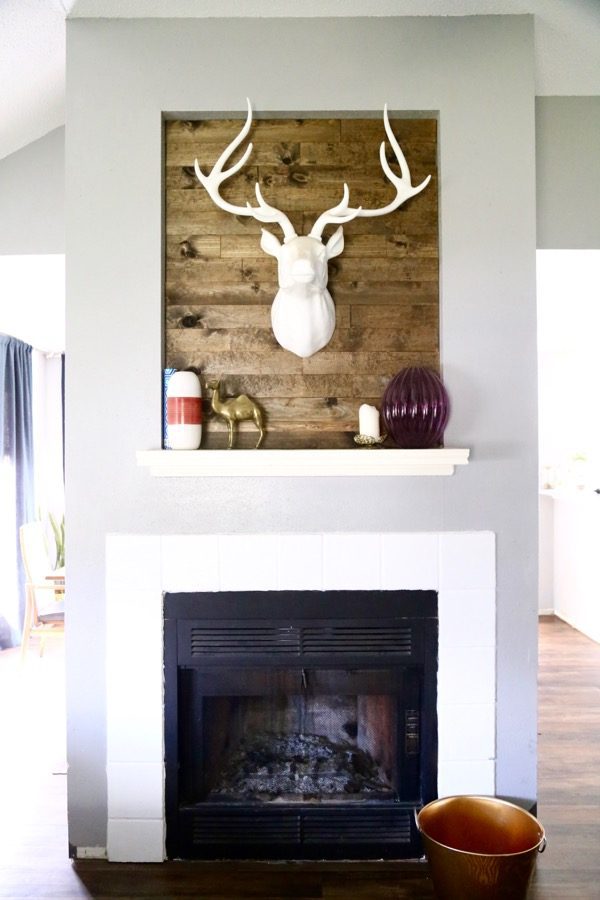 This wood-paneled fireplace was created under an hour for about $30! The transformation is incredible, and this project is so easy! You can use this tutorial to make a plank wall anywhere you want!