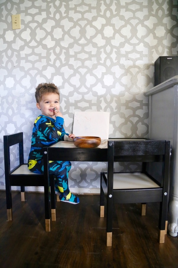 a toddler sitting a small ikea play table