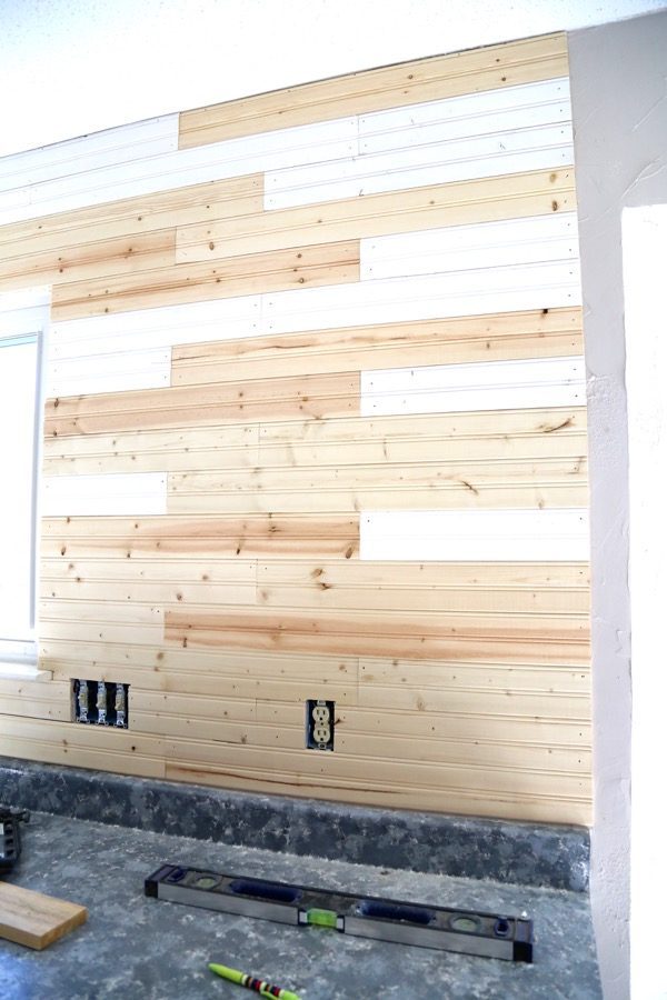 Unpainted beadboard backsplash on wall