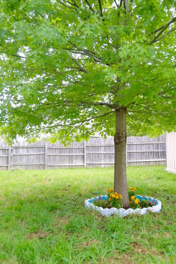 Do you want to WANT to spend more time in your backyard? Try making it a little prettier with some flowers! This post will show you how to brighten up your backyard with some color and fun by building a DIY border garden around a tree! It's quick, affordable, and it makes a big impact!