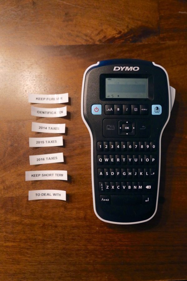 Label maker with various labels on a table