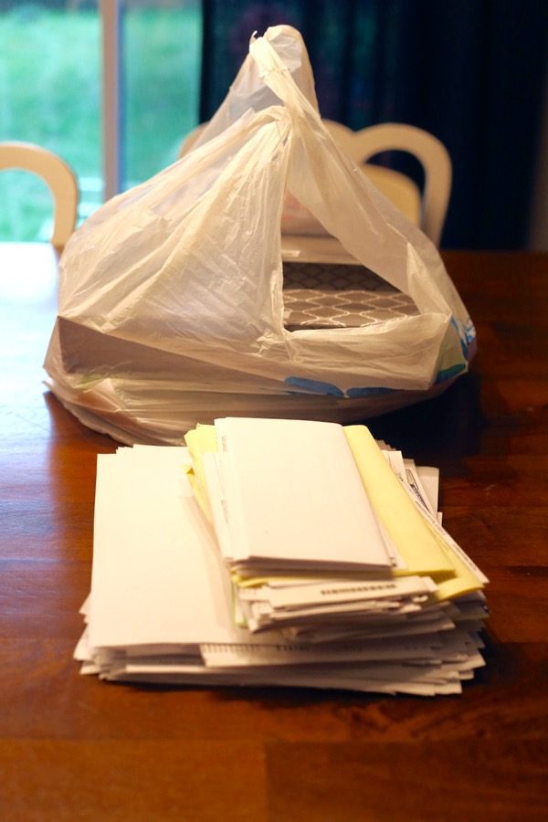 A stack of paper clutter on a table
