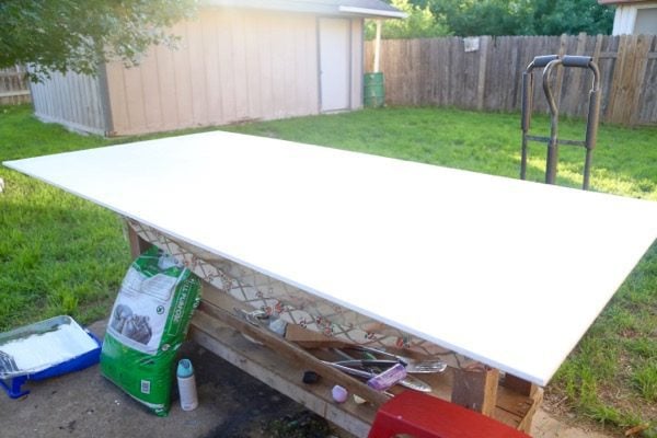 A plywood board primed and ready to be painted with chalkboard paint