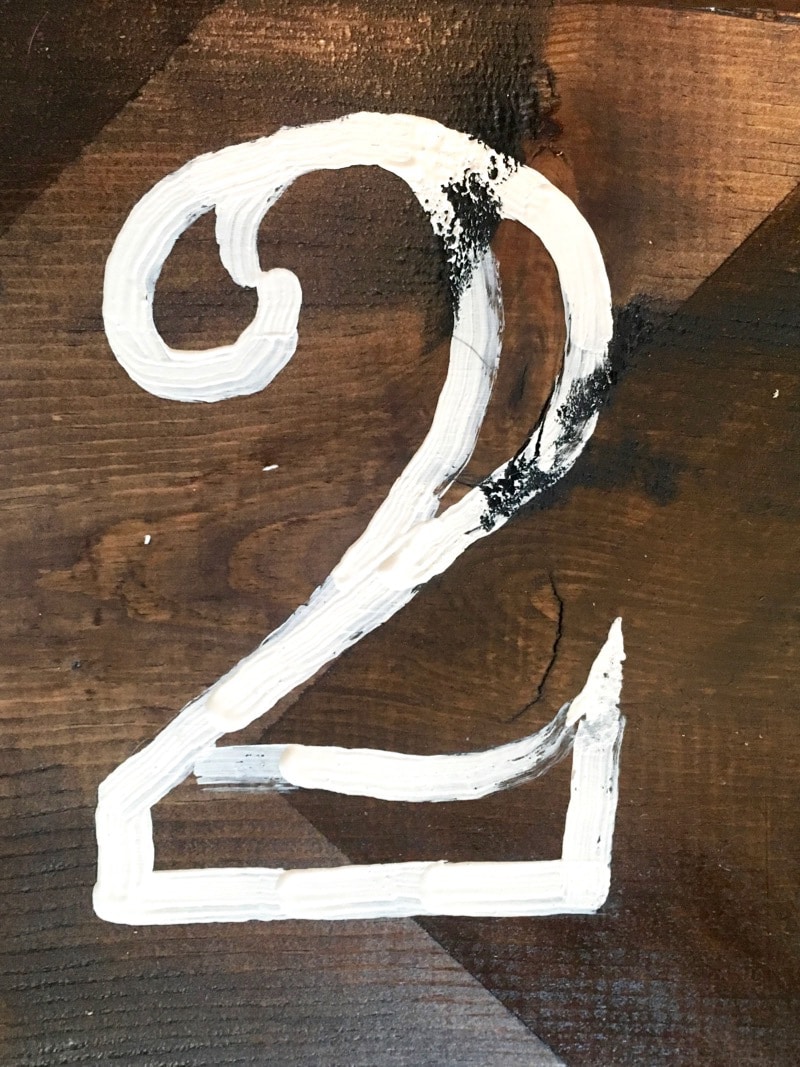 the number 2 outlined on a piece of wood