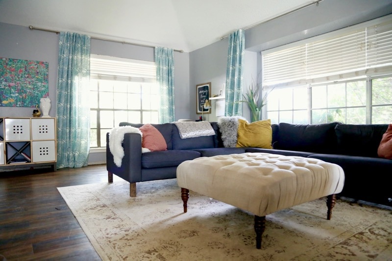 living room with a sectional sofa and colorful accessories