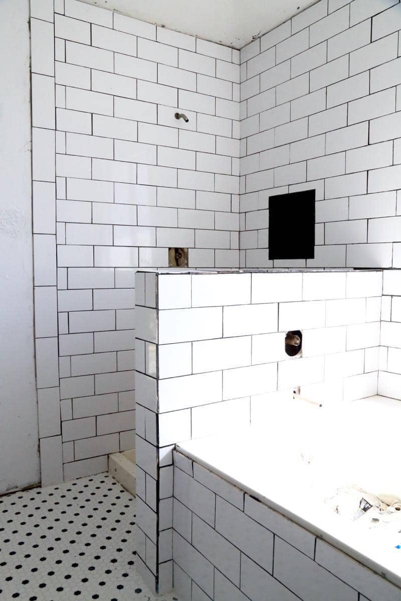 This bathroom renovation is going to be amazing. The black and white tile in this room is so clean and modern! There are some great tips for tiling in this post, too. This One Room Challenge makeover is going to be absolutely amazing.