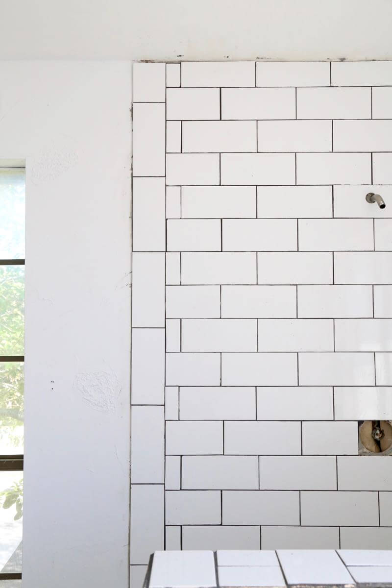 This bathroom renovation is going to be amazing. The black and white tile in this room is so clean and modern! There are some great tips for tiling in this post, too. This One Room Challenge makeover is going to be absolutely amazing.