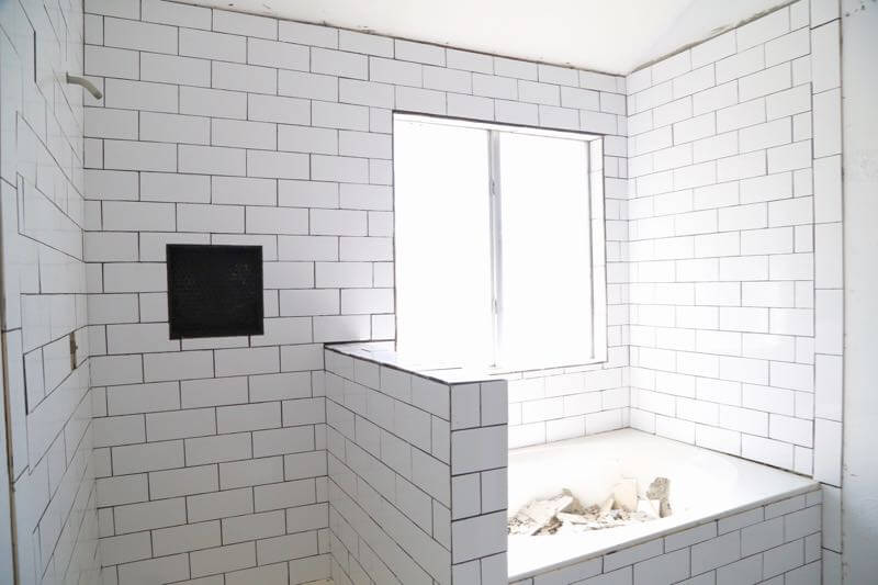 This bathroom renovation is going to be amazing. The black and white tile in this room is so clean and modern! There are some great tips for tiling in this post, too. This One Room Challenge makeover is going to be absolutely amazing.