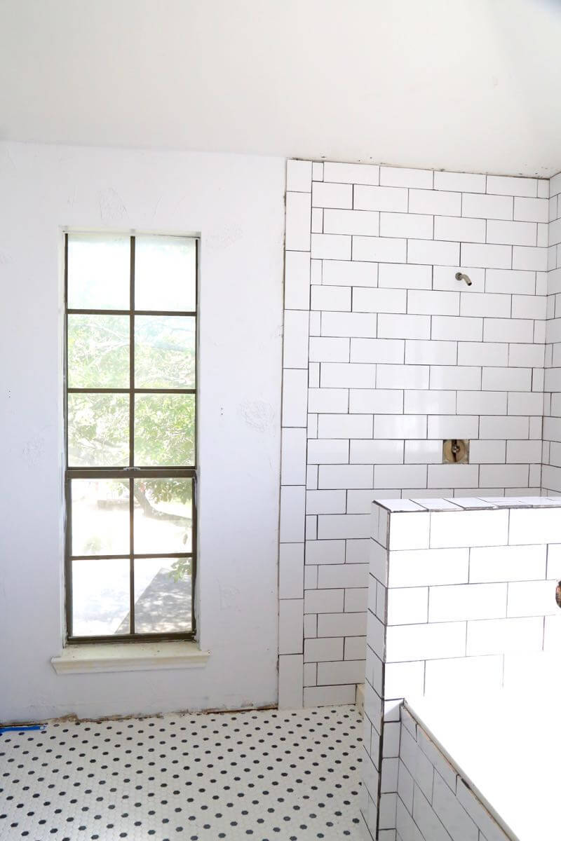 This bathroom renovation is going to be amazing. The black and white tile in this room is so clean and modern! There are some great tips for tiling in this post, too. This One Room Challenge makeover is going to be absolutely amazing.