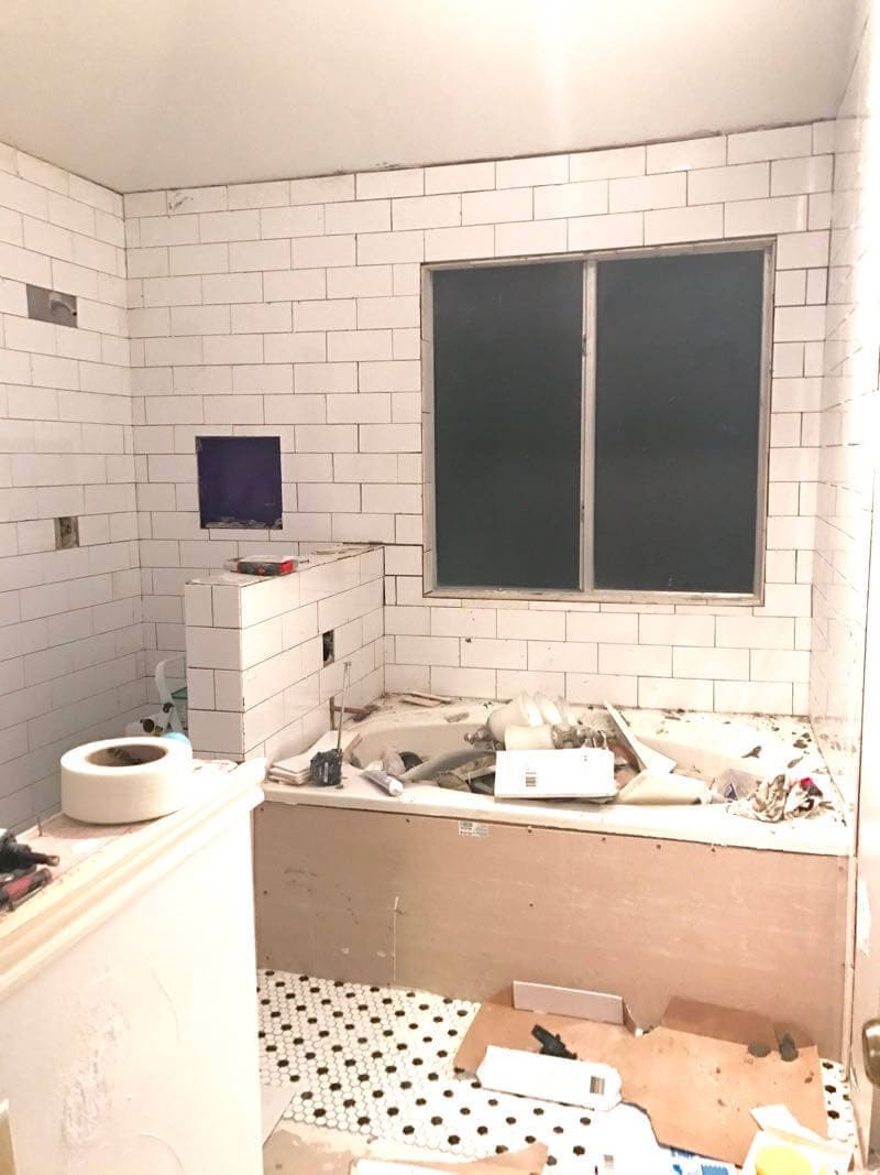 This bathroom renovation is going to be amazing. The black and white tile in this room is so clean and modern! There are some great tips for tiling in this post, too. This One Room Challenge makeover is going to be absolutely amazing.