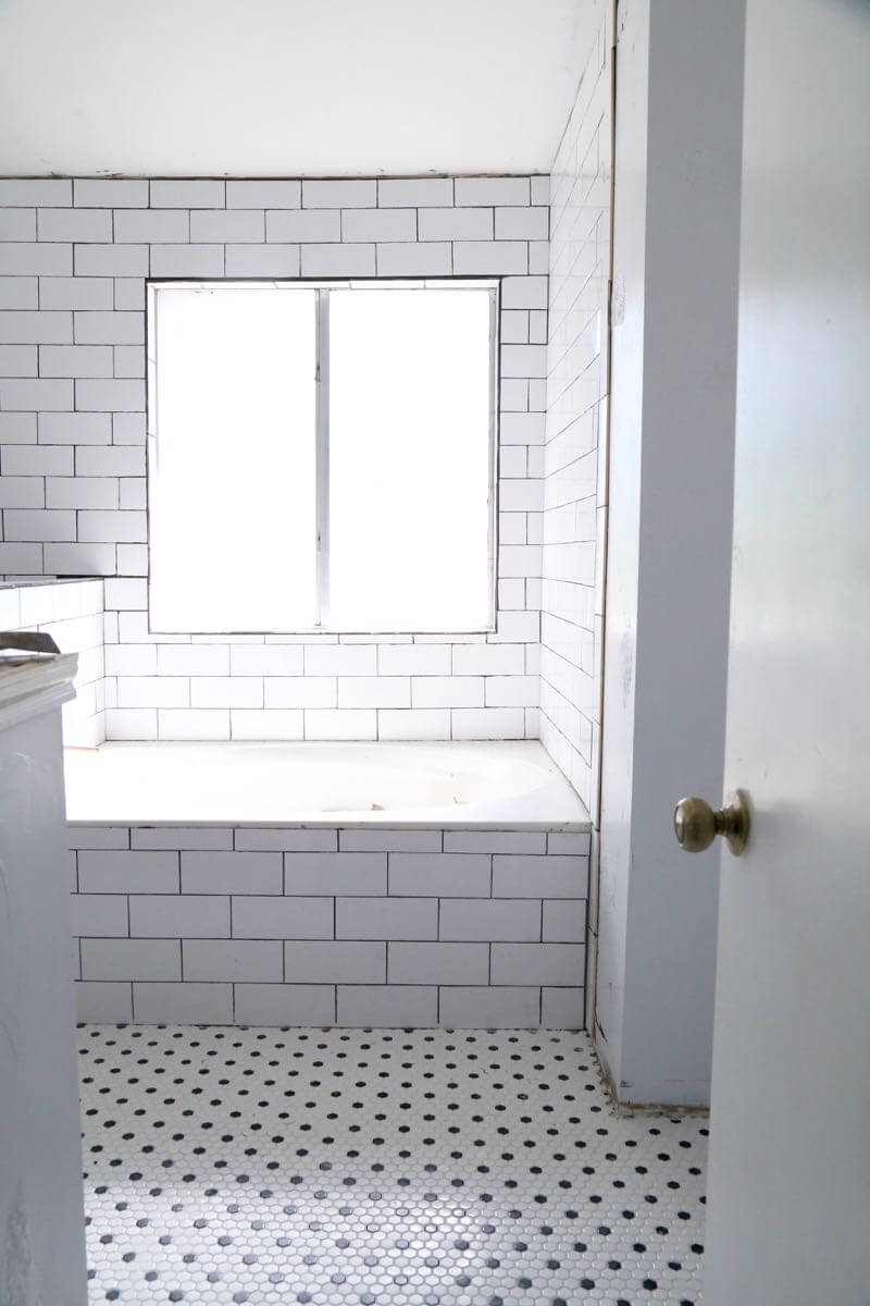 This bathroom renovation is going to be amazing. The black and white tile in this room is so clean and modern! There are some great tips for tiling in this post, too. This One Room Challenge makeover is going to be absolutely amazing.