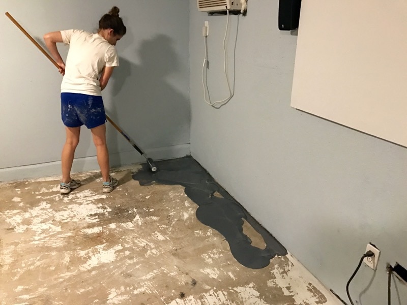 woman Applying Rock Solid from Rustoleum garage floor coating 