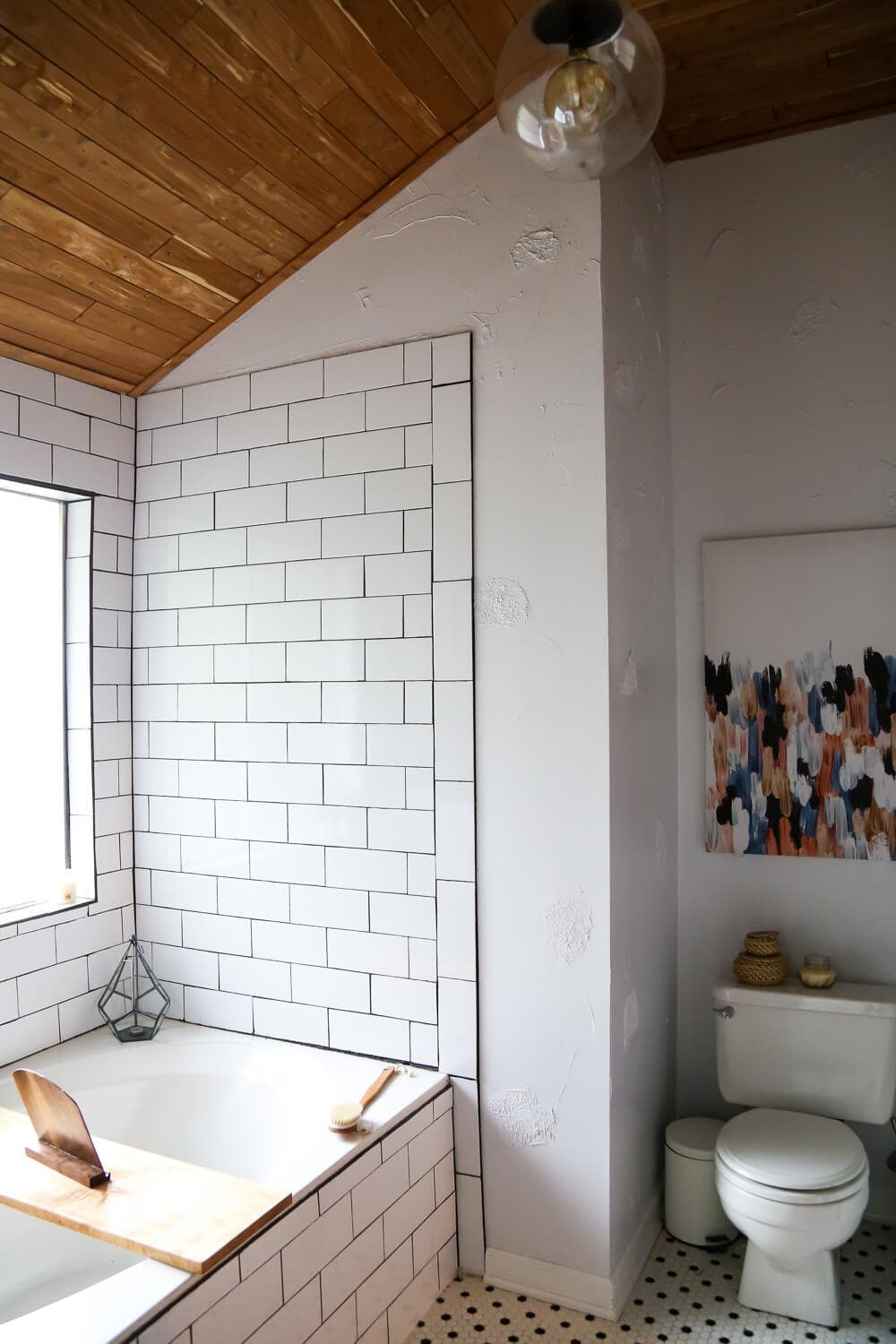 Master bathroom renovation with white subway tile and cedar planked ceiling