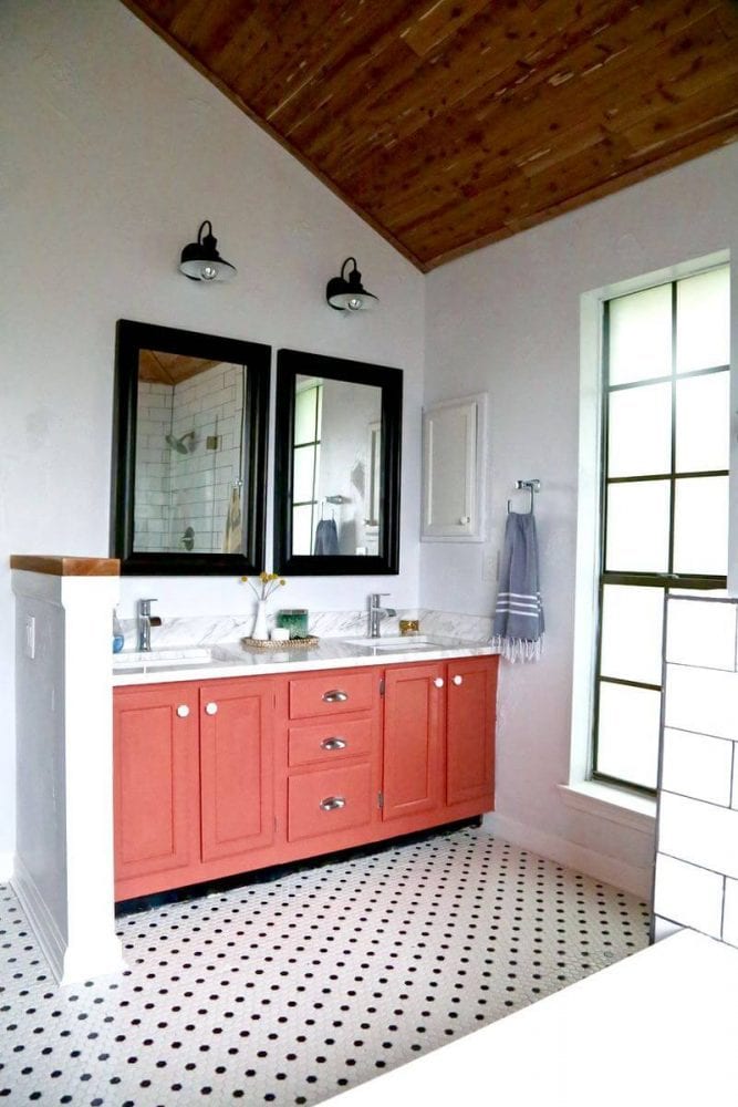 a black and white bathroom with a pink vanity