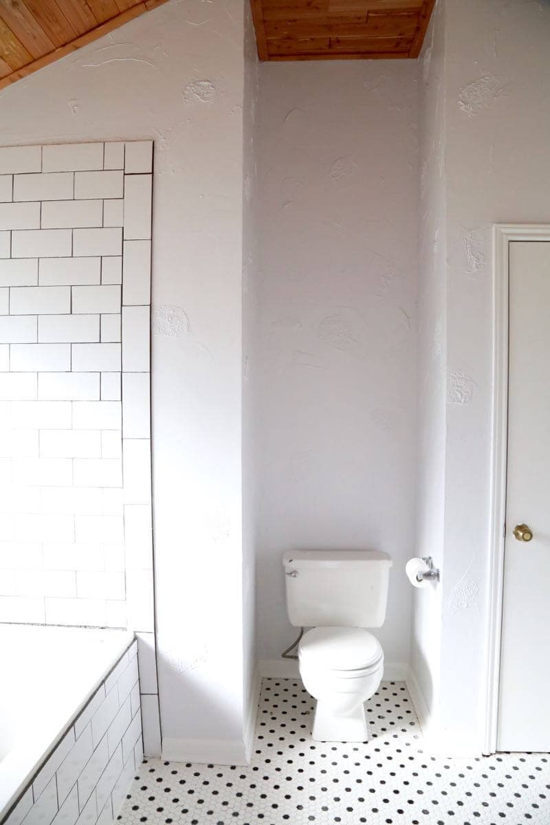 This master bathroom is so clean, bright, and serene! Love the black and white tile and the cedar planked ceiling!