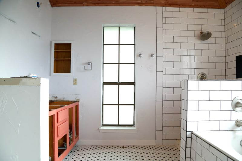 This master bathroom is so clean, bright, and serene! Love the black and white tile and the cedar planked ceiling!