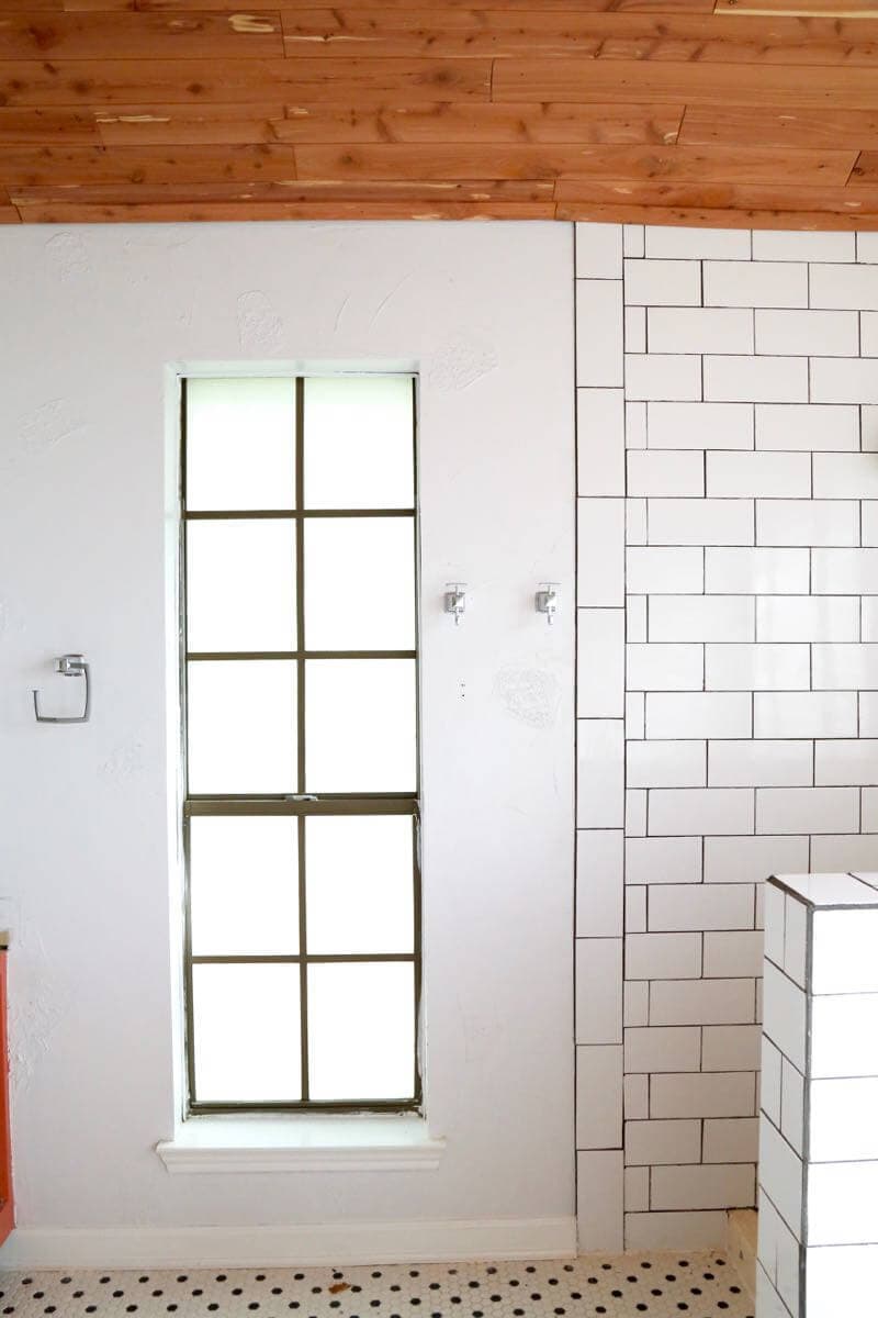 This master bathroom is so clean, bright, and serene! Love the black and white tile and the cedar planked ceiling! 