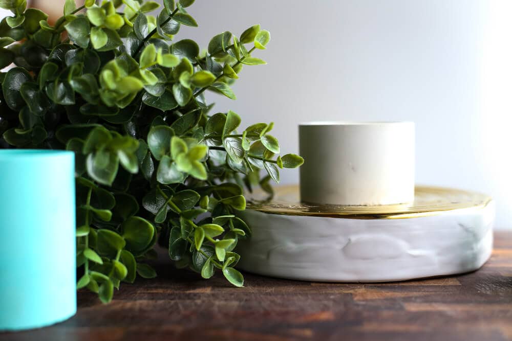 Homemade candles sitting on a wood table