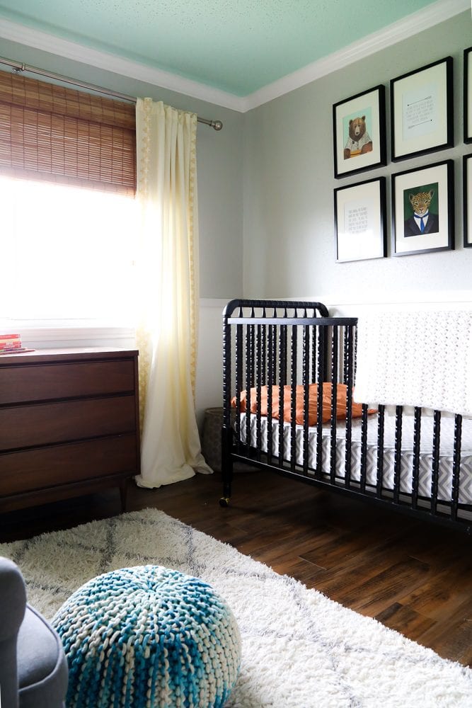 a nursery with a blue ceiling