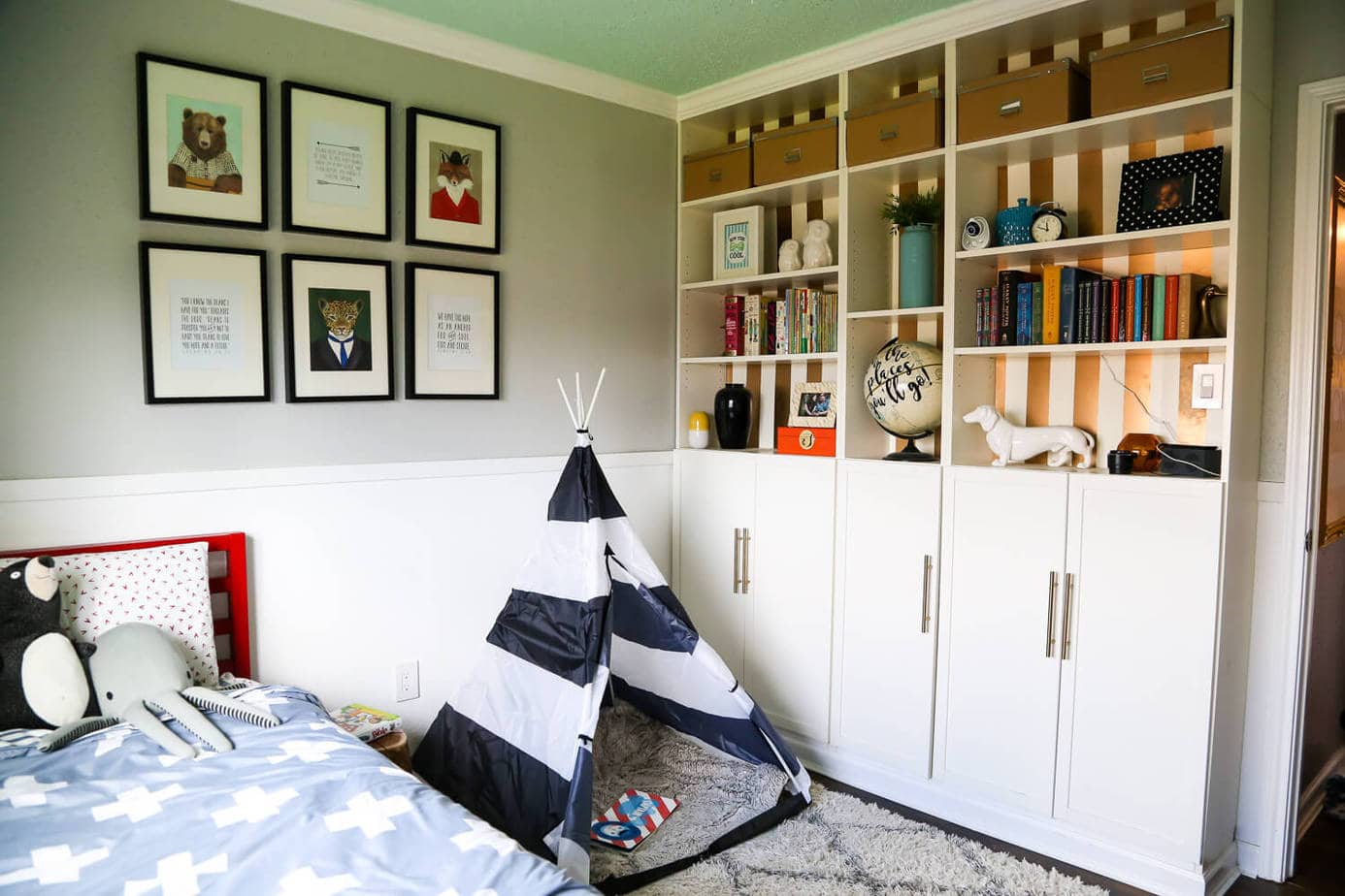A gender neutral kid room with built in billy bookcases