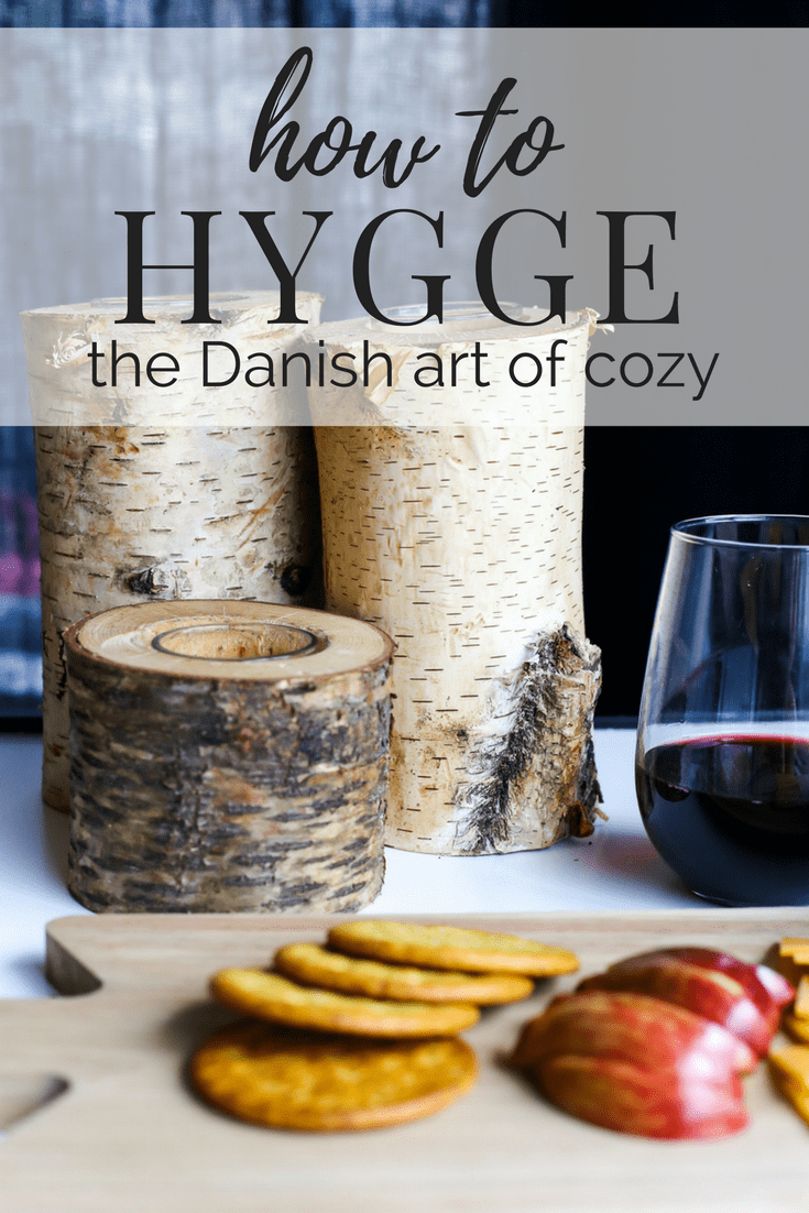 A cozy setup with fruits, candles, and wine - all about how to hygge