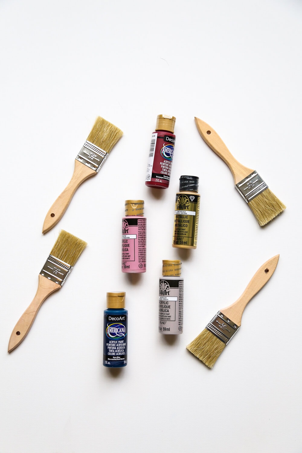 An assortment of paintbrushes and acrylic paints