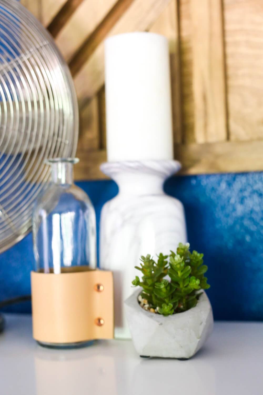 How to create a gorgeous large-scale geometric wood wall art piece for your home. You just need some glue and a saw to cut it down! It's so easy that even a total beginner can do it, and it's absolutely gorgeous!