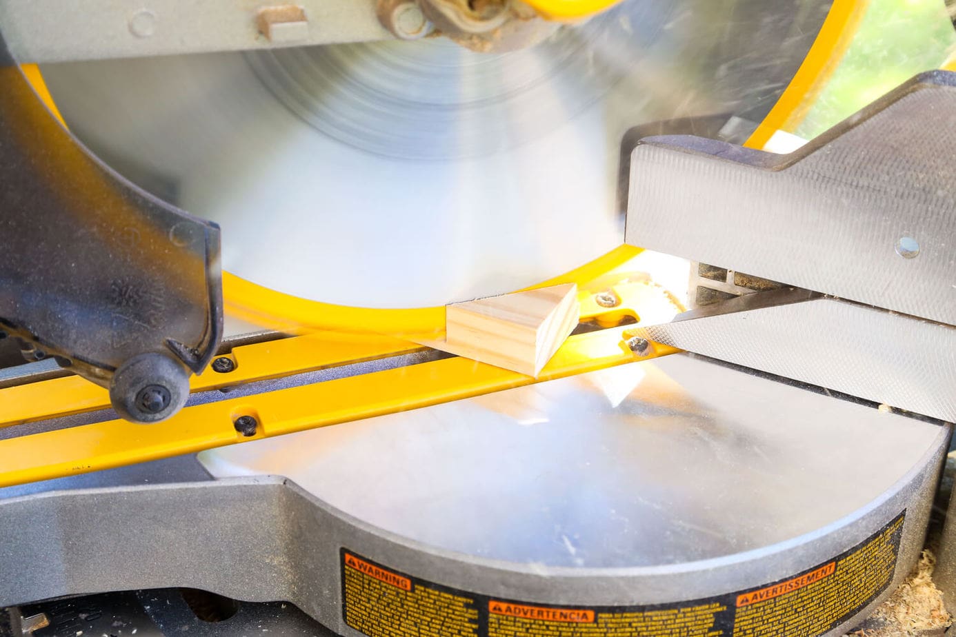 Close up of miter saw making a 45-degree cut