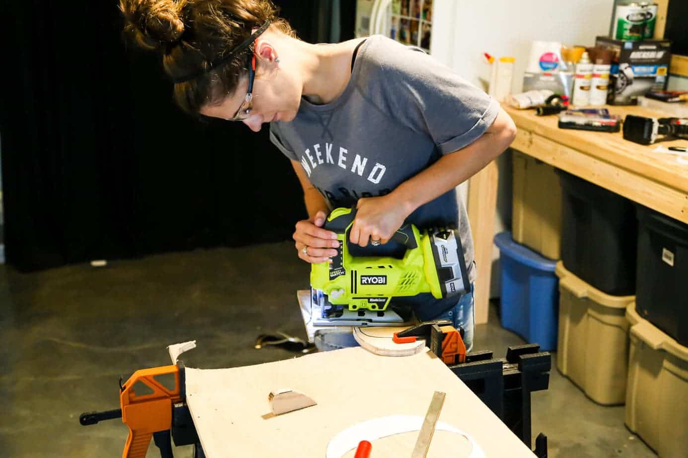 woman using a jigsaw to cut wood