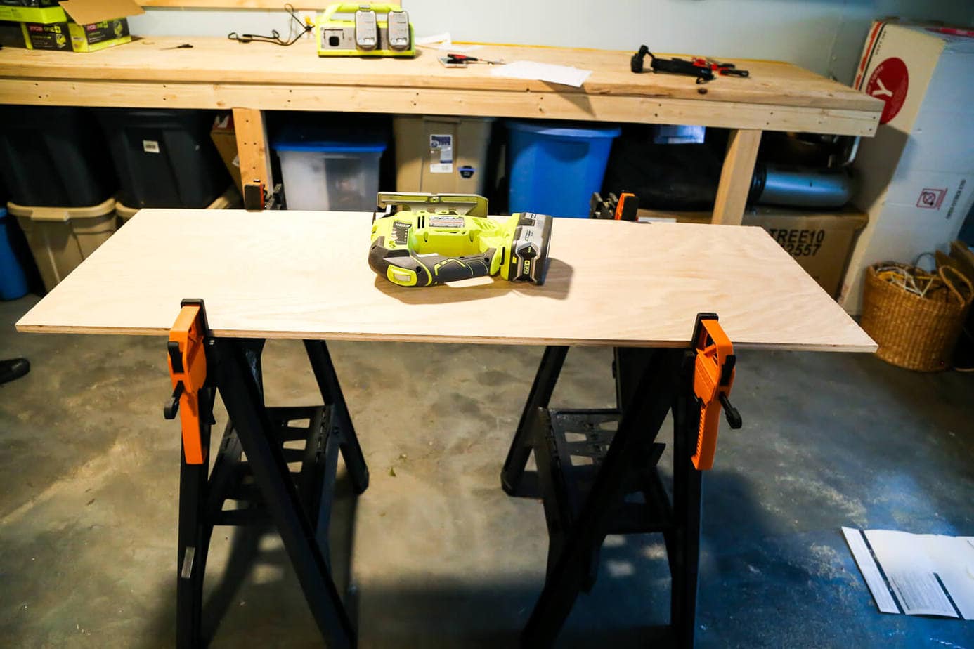 a piece of plywood clamped to a sawhorse