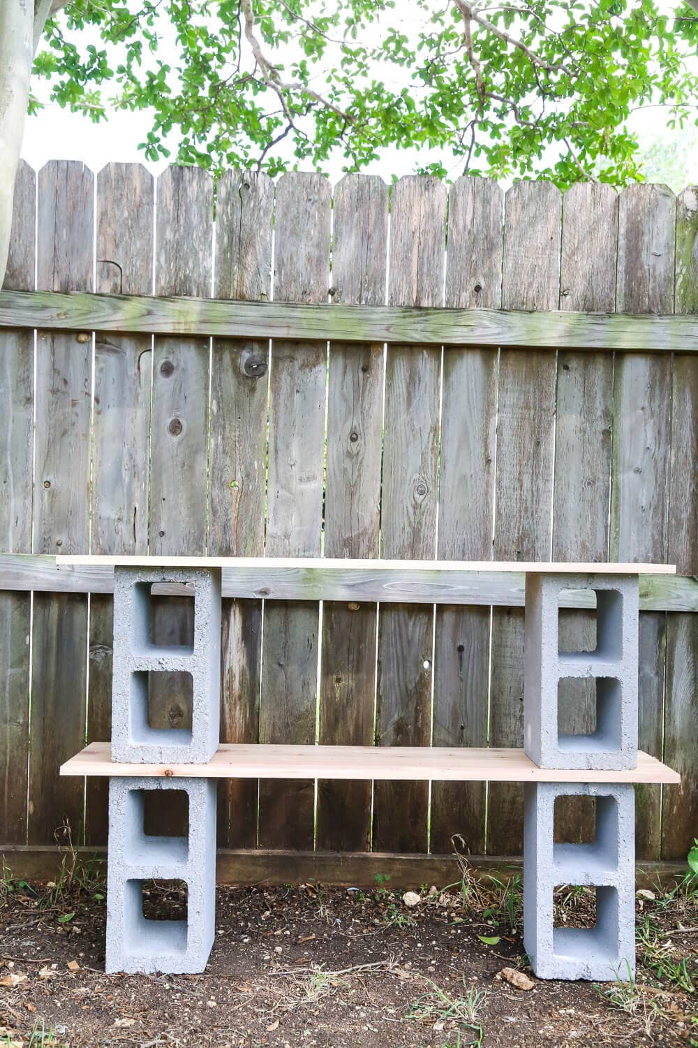 How to build simple cinderblock shelves to hold your plants. A really quick and simple plant stand idea - perfect for herb gardens, succulents, or whatever plants you need a space for!