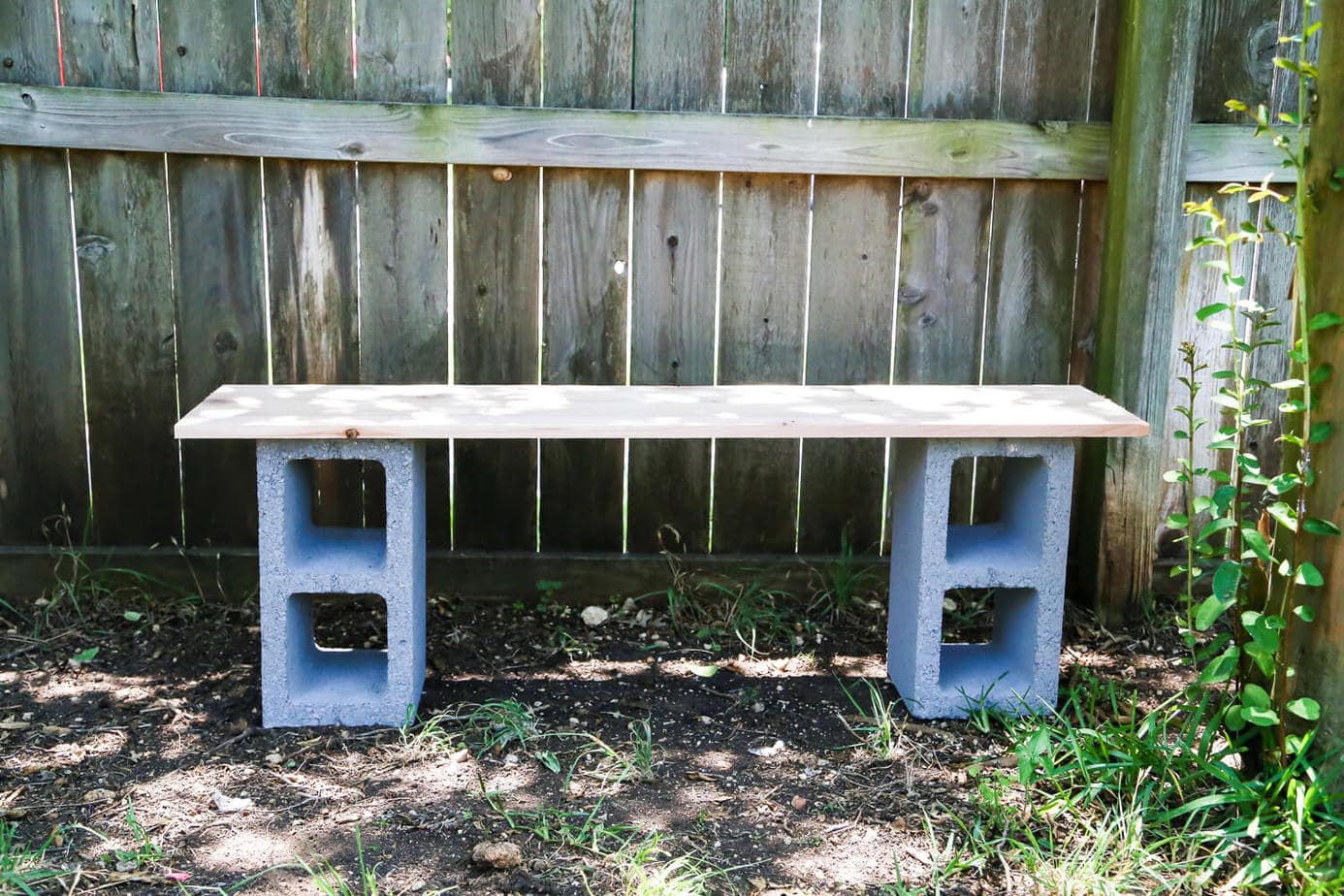 How to build simple cinderblock shelves to hold your plants. A really quick and simple plant stand idea - perfect for herb gardens, succulents, or whatever plants you need a space for!