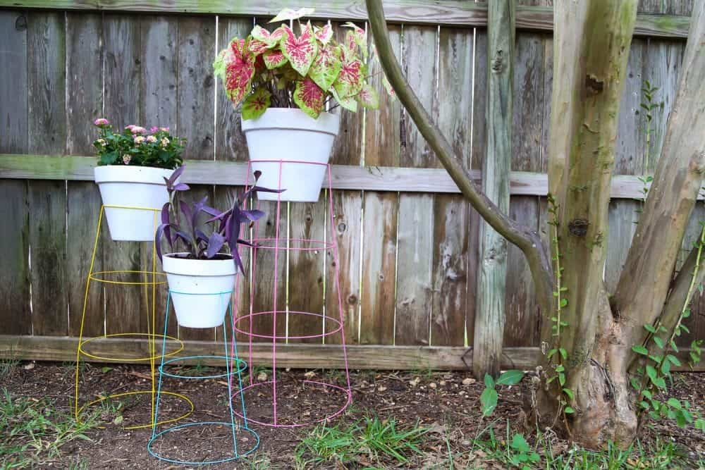 How to make DIY plant stands from tomato cages in just 15 minutes for less than $20. They're so easy, colorful, and fun and they're a great way to display your favorite plants!