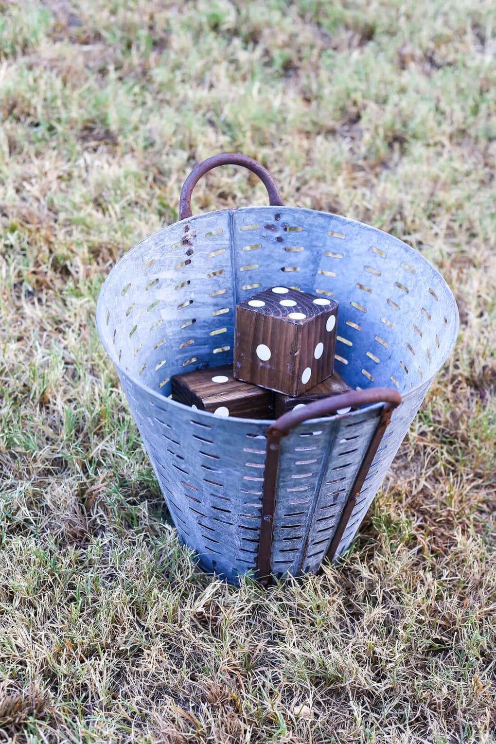 Wooden yard dice in an olive bucket