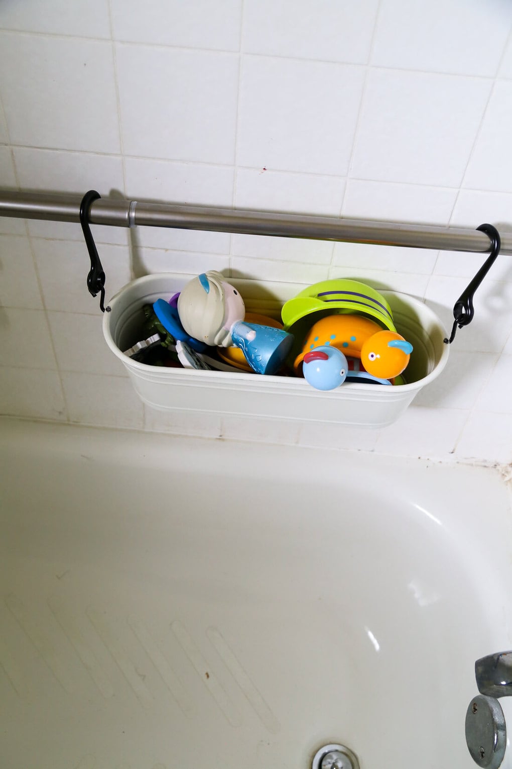 How to organize your bath toys in an attractive and affordable way using the FINTORP hanging baskets from IKEA. No more dripping toys in the middle of your bathtub! 