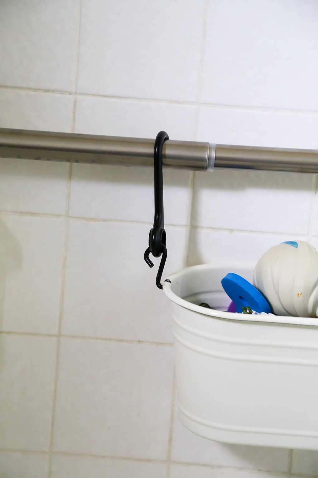 basket hanging from a shower rod