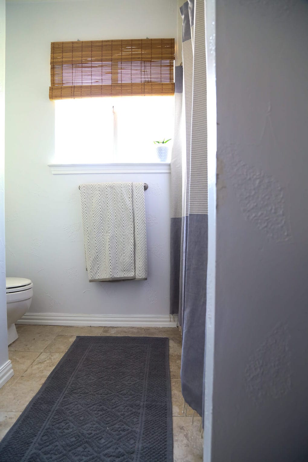 A DIY modern, serene bathroom renovation that can be completed in a weekend. Great ideas for how to upgrade an ugly bathroom and make it look like new without a ton of time or money. 