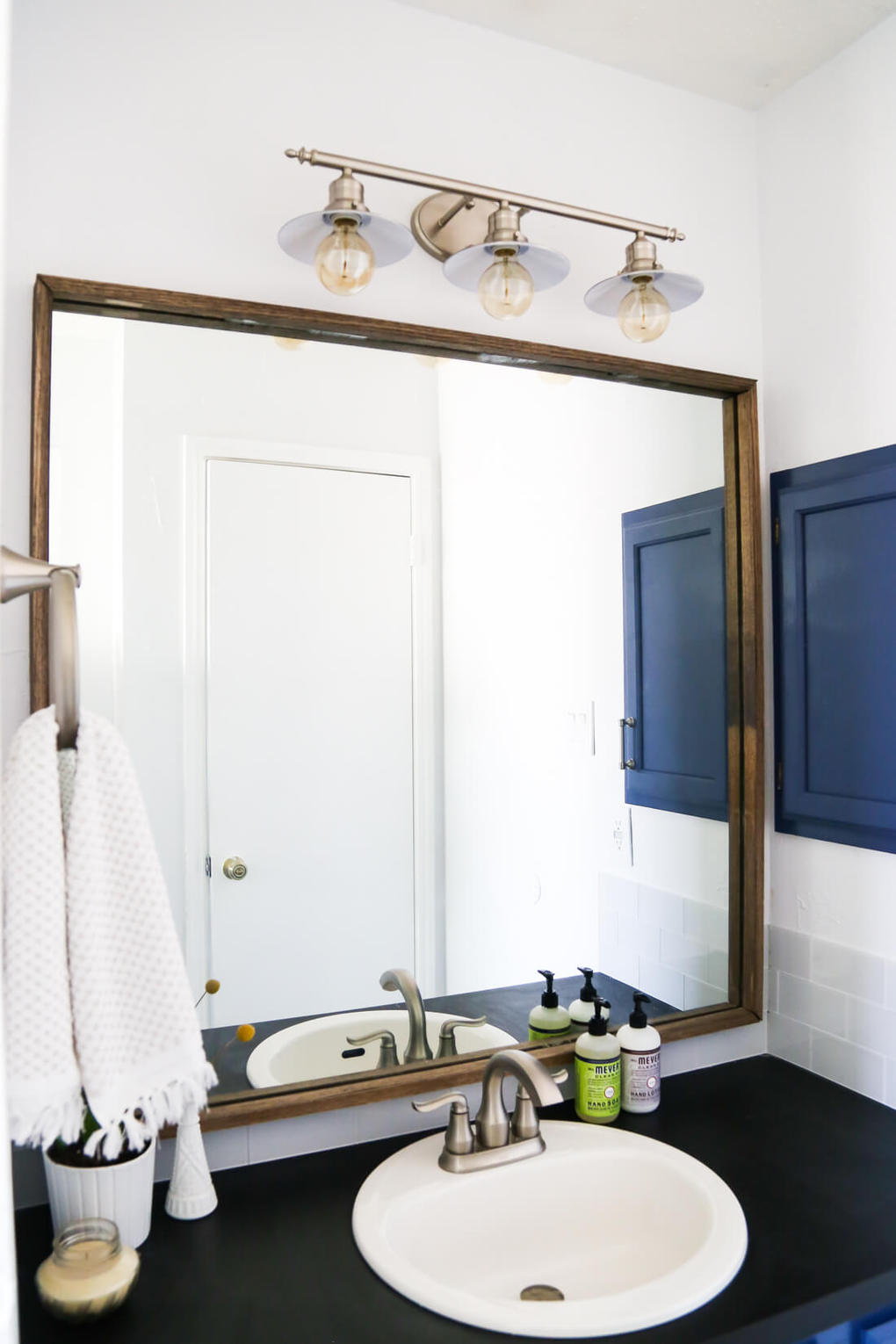 How to quickly and easily frame a bathroom mirror, to take your bathroom from builder-grade to completely custom!