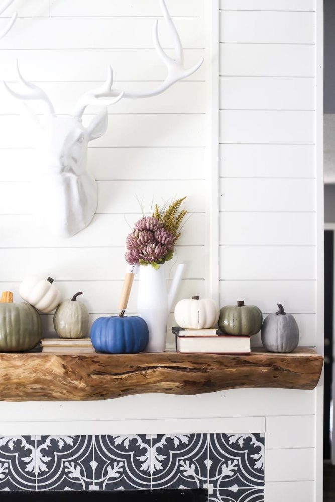 fireplace with painted pumpkins