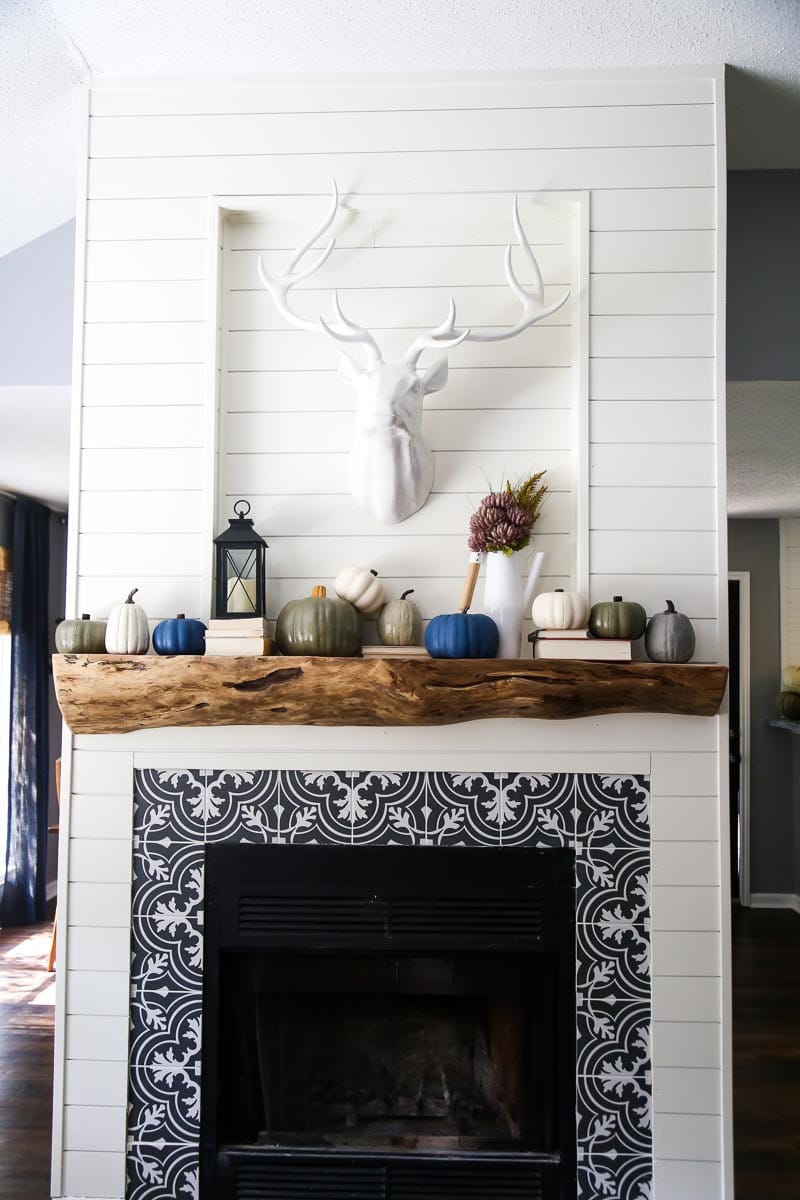 a fireplace decorrated for fall