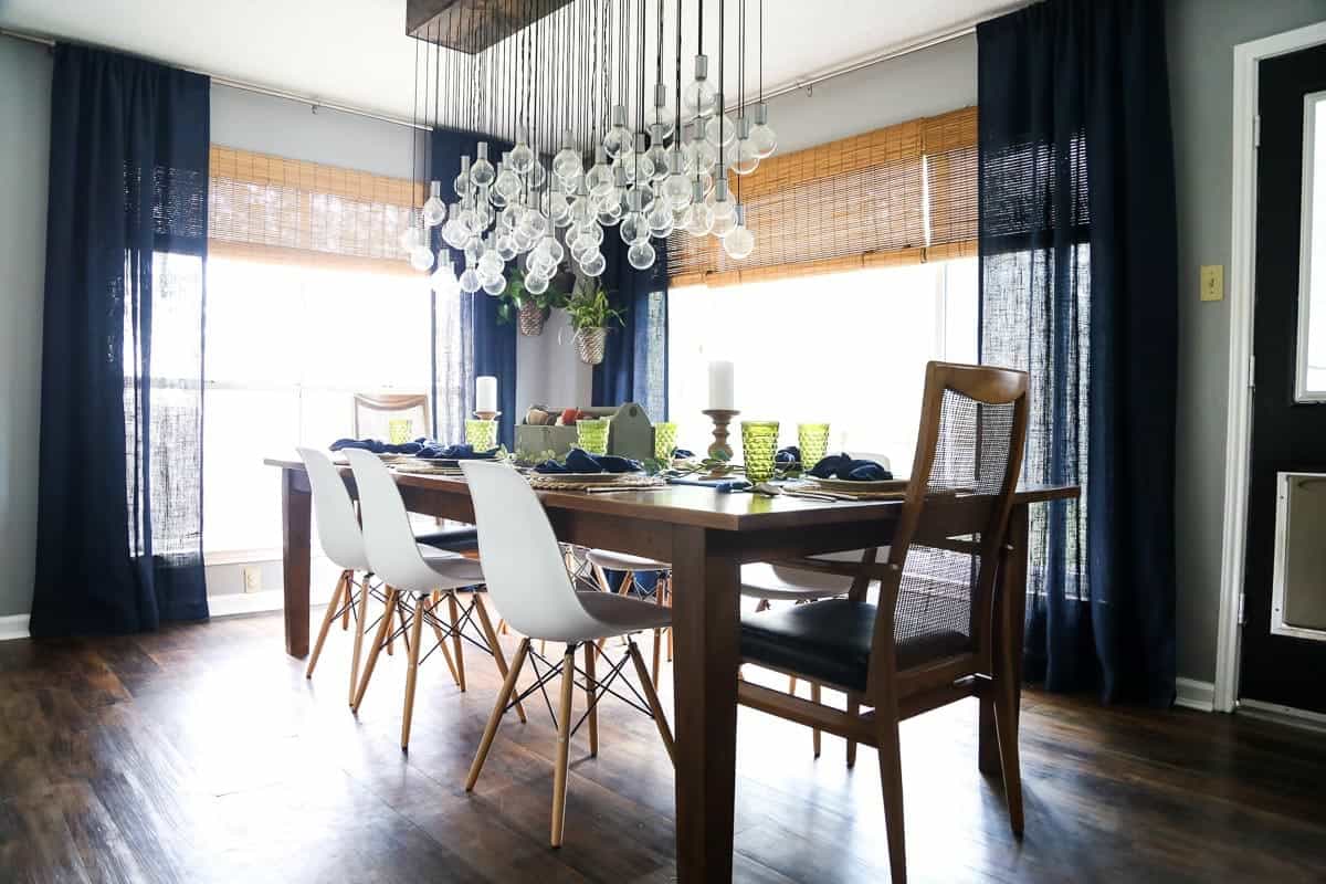 Dining room with a large dining table and a large, multi-bulb chandelier