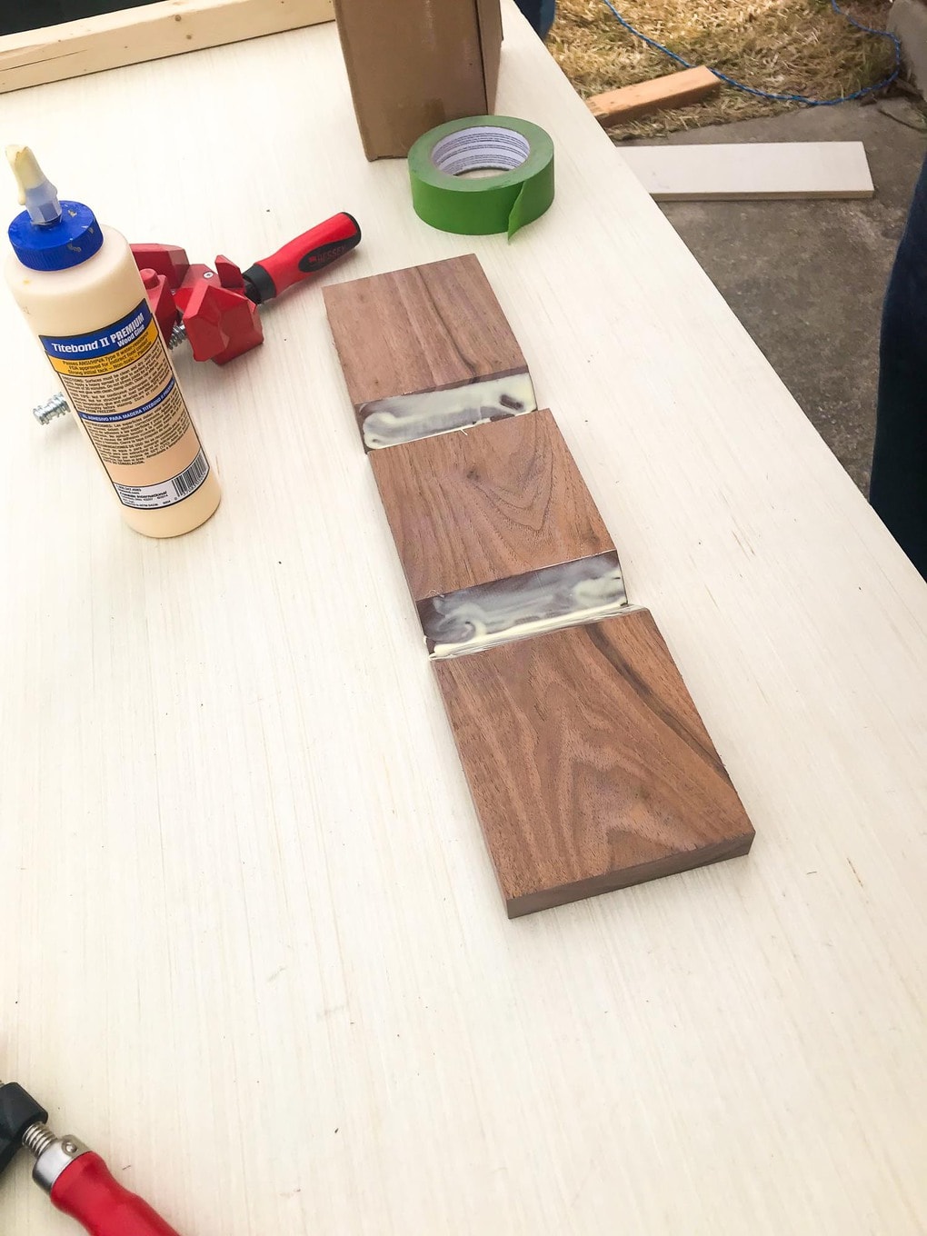 Sofa arm table pieces being glued