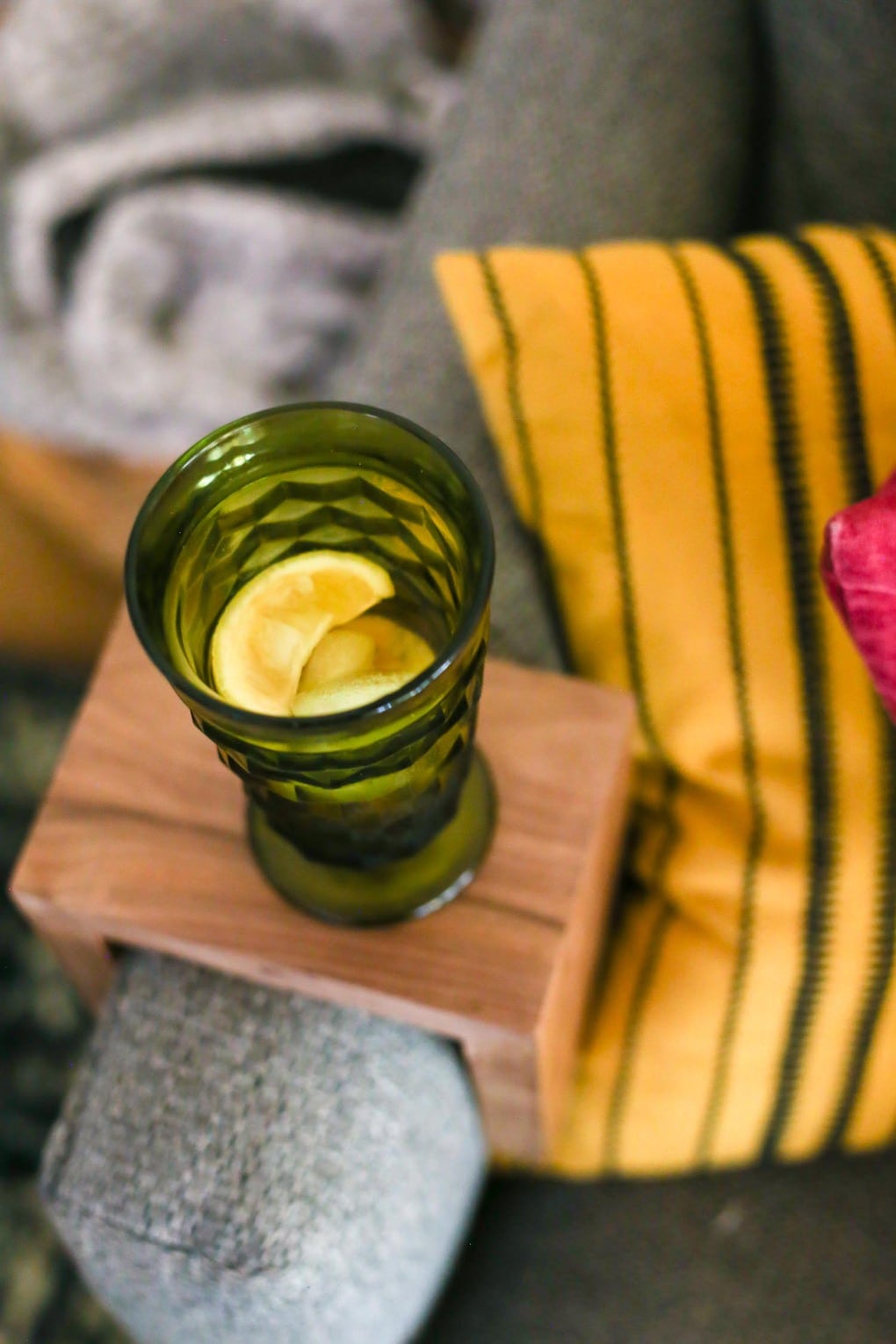 Close up of sofa arm table with drink on top