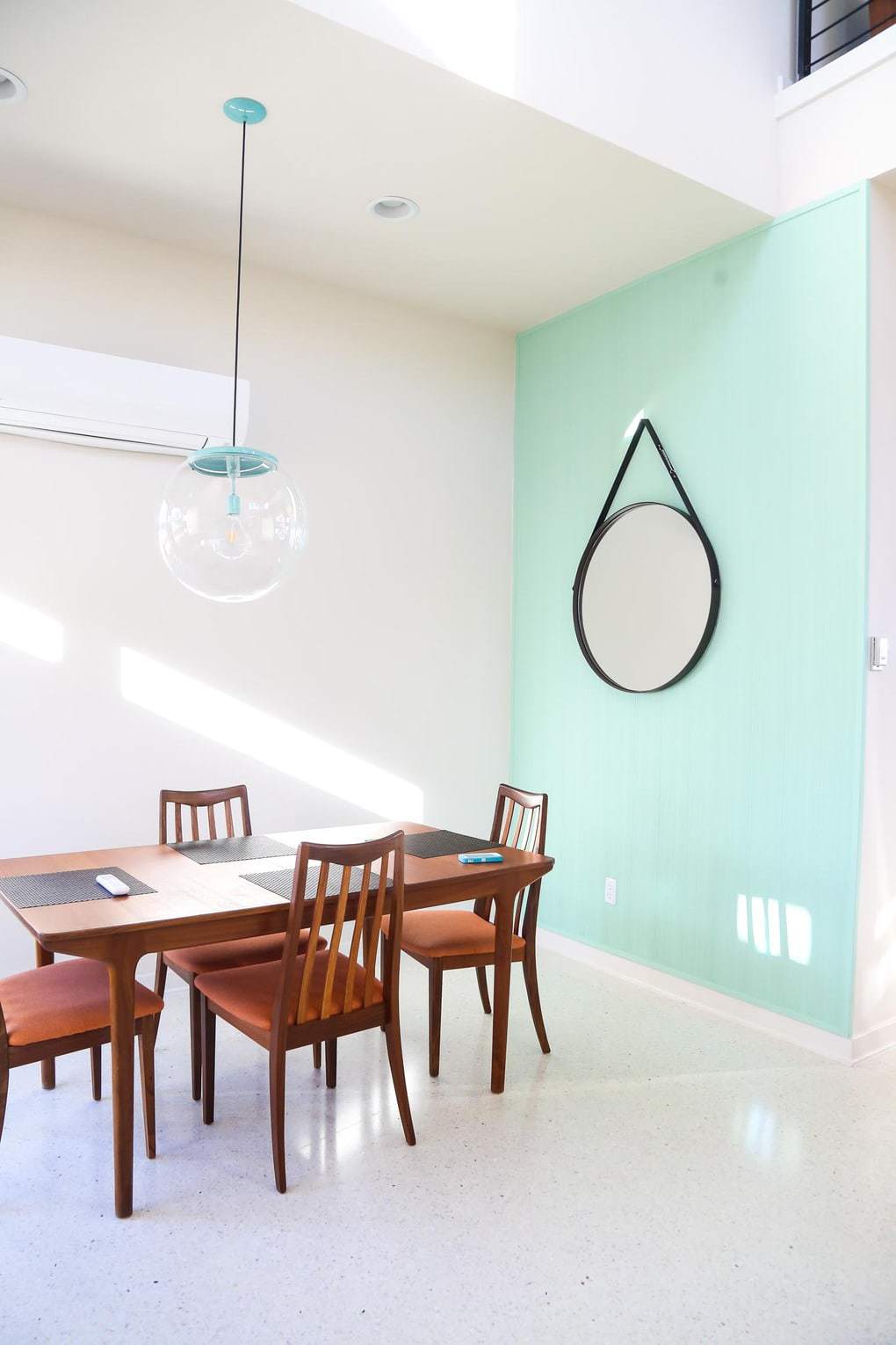 Gorgeous mid-century modern dining room with blue paneling - designed by Starlight Village Homes