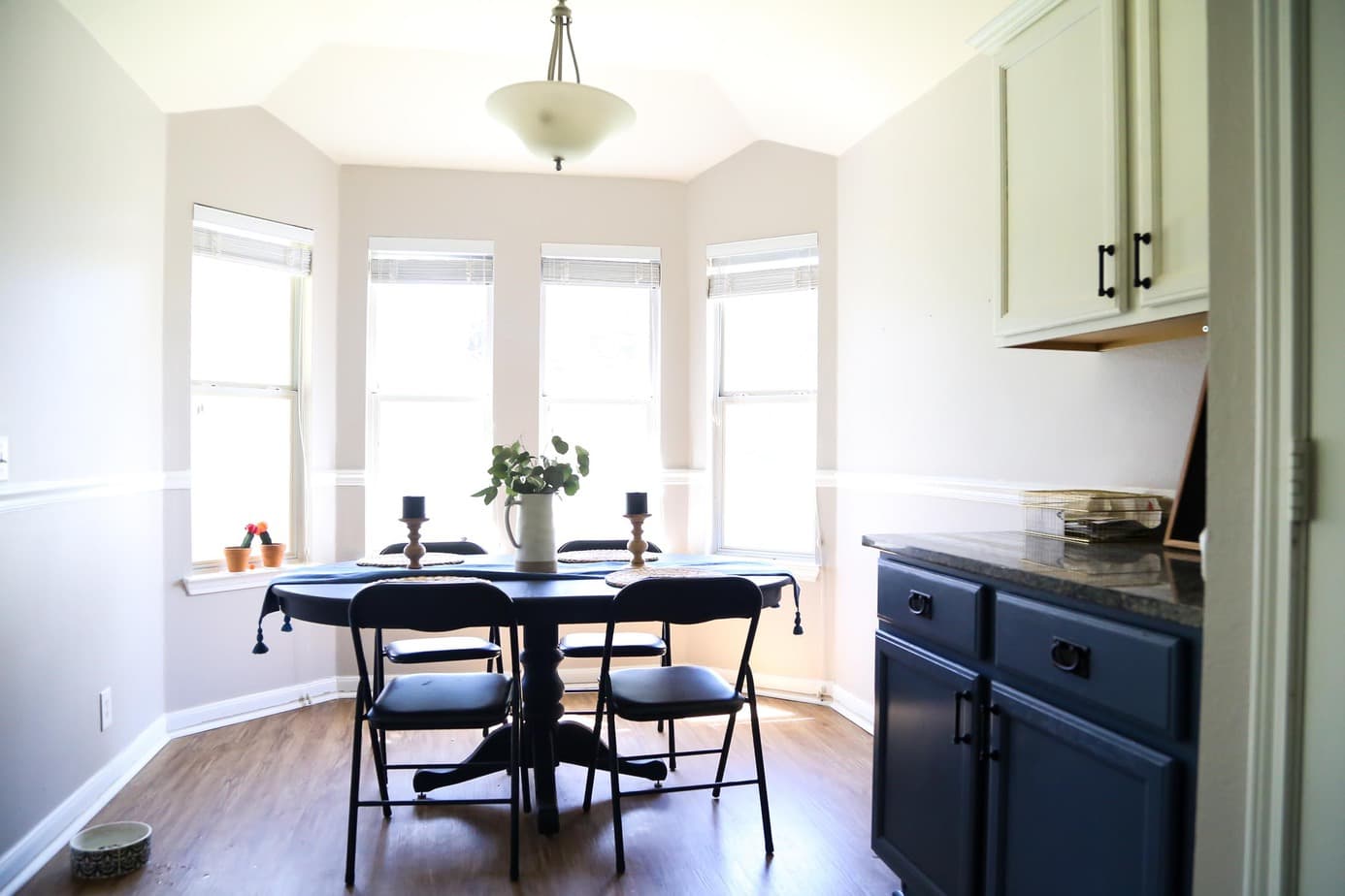 Small dining room with black table and four chairs