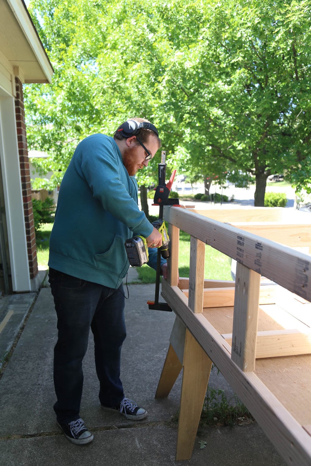 man working on building a base for DIY bay window seating