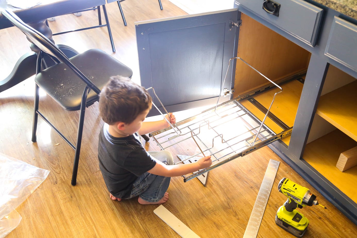 Installing a hidden pull-out trash can beneath a cabinet