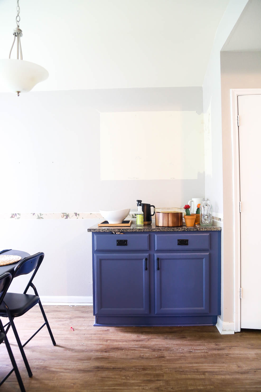 This blue kitchen cabinet has a hidden trash can! 