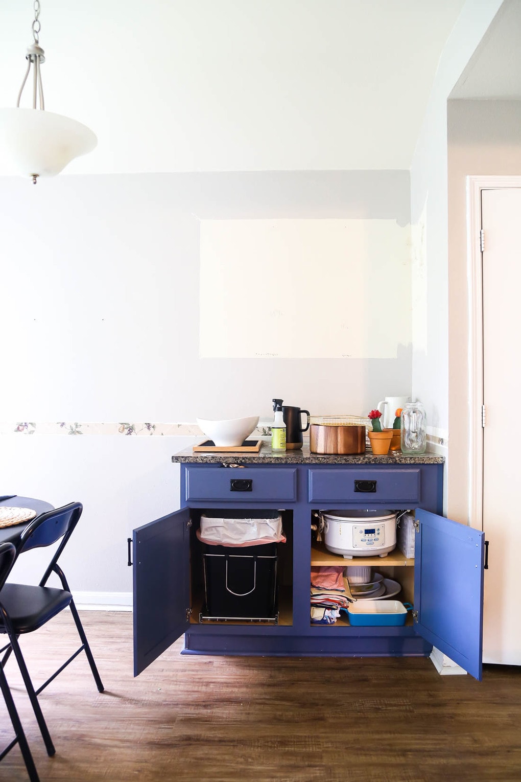 How to hide a trash can under a cabinet