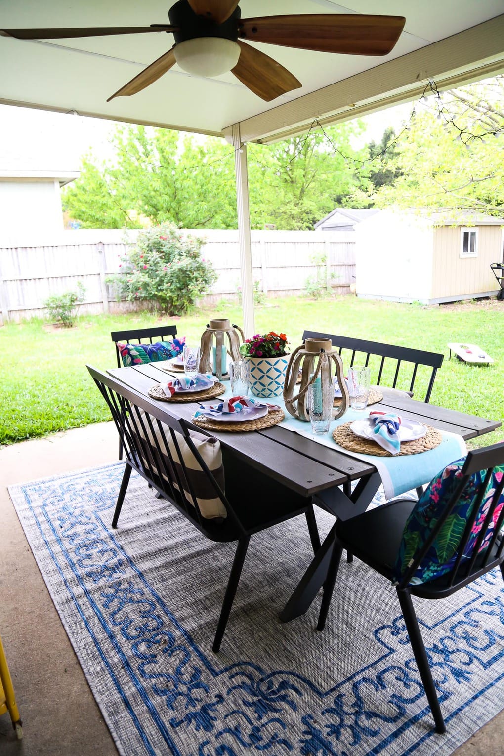 Back patio with a table, two benches, and two chairs